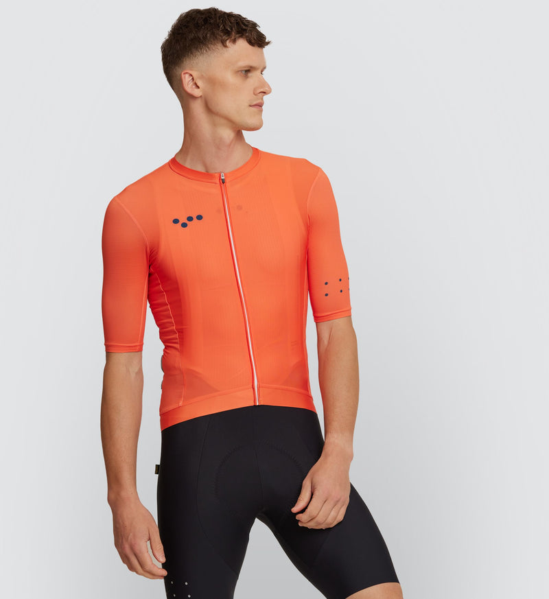 Front view of cyclist wearing the Tangerine Classic Cycling Jersey, showcasing breathable fabric and secure fit