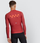 Side view of a cyclist wearing the Astro Dust Men's Classic Long Sleeve Jersey, highlighting the underarm ventilation and sleek design for enhanced airflow.