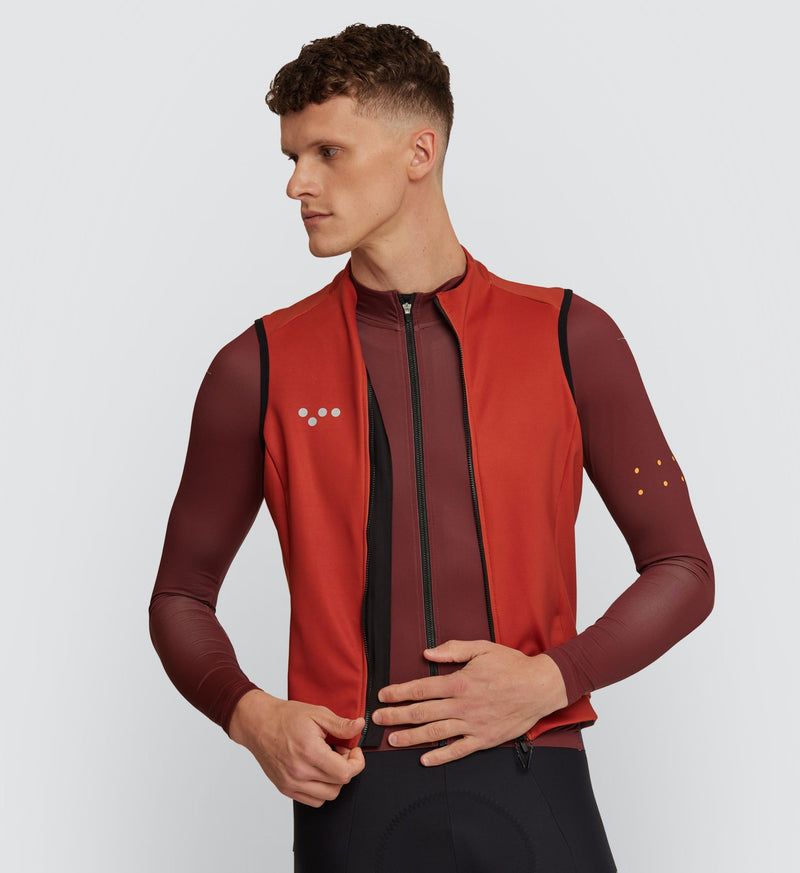 Front view of cyclist wearing Paprika Thermal Cycling Gilet with high stand collar and YKK Vislon® zipper