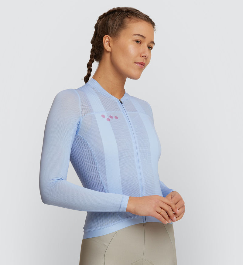 Front view of female cyclist in Sky Air Long Sleeve Jersey, showcasing sleek silicone hem and YKK zipper