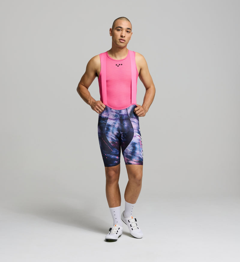 Male cyclist wearing the DENIM / Men's SuperFIT 2.0 Cycling Bib Short in Purple Haze, highlighting its advanced brace system and aerodynamic fit.