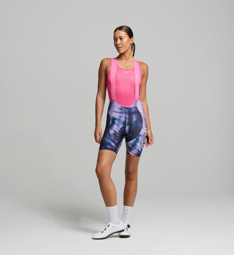 Female cyclist wearing the DENIM / Women's SuperFIT 2.0 Bib Short in Purple Haze, highlighting the advanced brace system and aerodynamic fit.