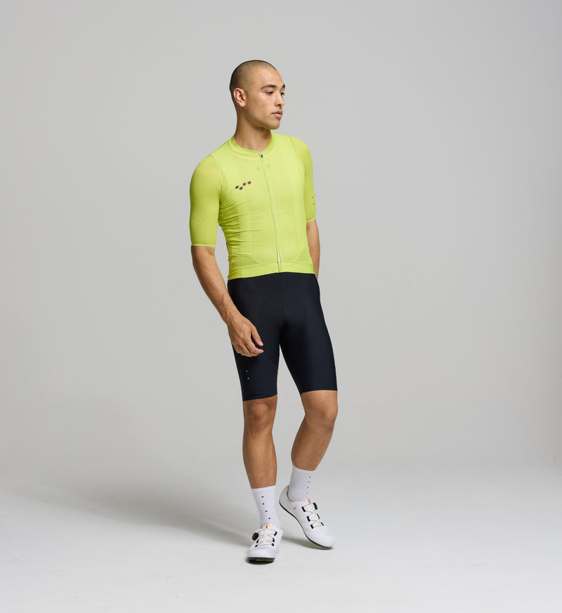 Front view of male cyclist in electric lime Air Jersey – slim, aerodynamic fit with mesh panels on chest and sleeves for cooling and sweat-wicking during high-output rides.