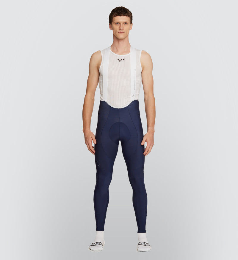 Front view of the Navy Men's SuperFLEECE 2.0 Cycling Bib Tights, showcasing a lightweight brace system for an optimal fit and ease of movement in cooler weather.