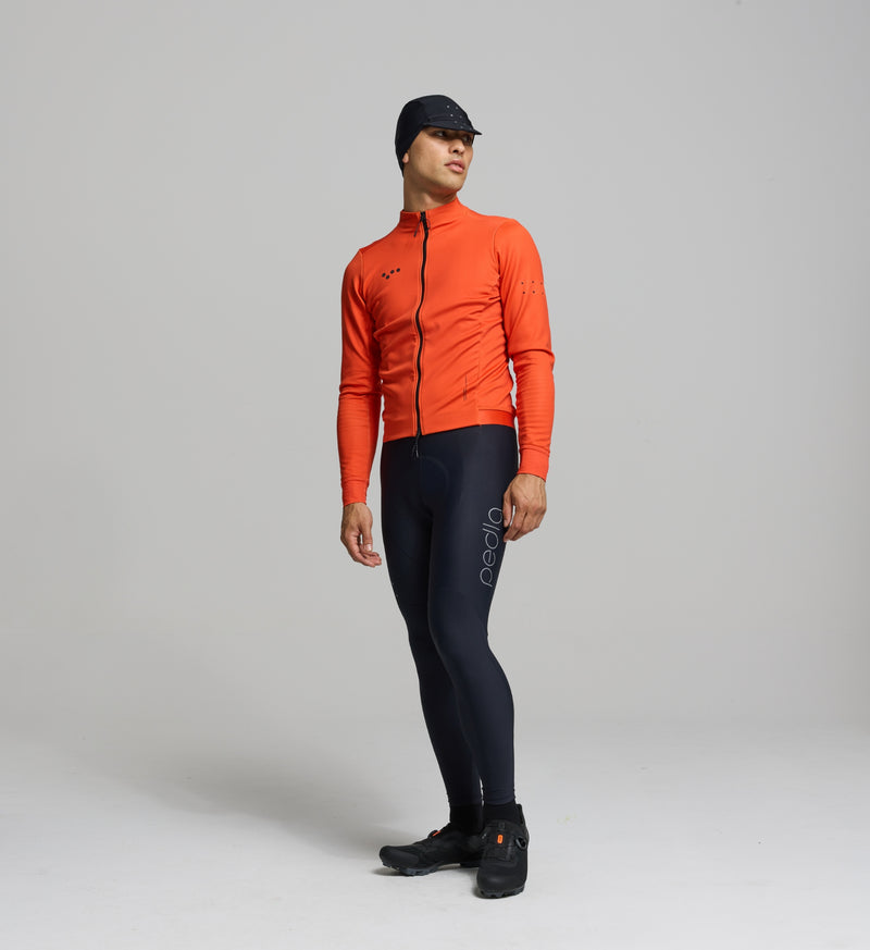Front view of male cyclist in amber Thermal Jacket – minimalist fit with wind-blocking front panels, SAB waterproof two-way zip, and soft thermal fabric for winter rides.