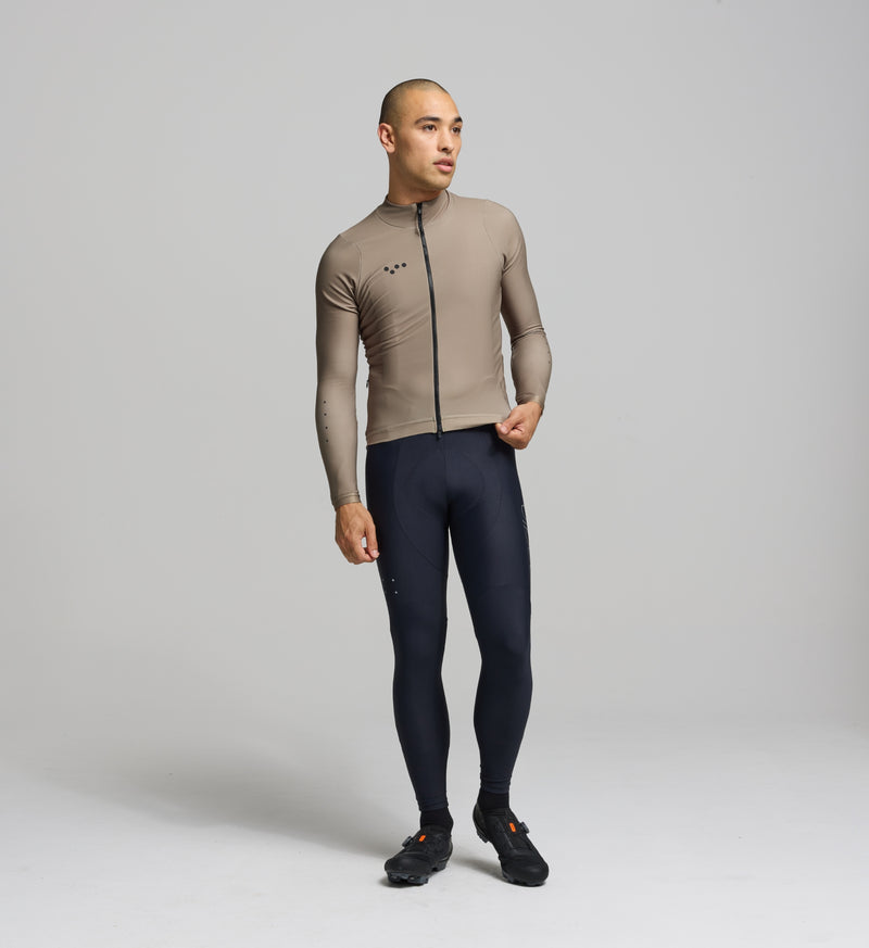 Front view of male cyclist wearing sandstone Thermal Long Sleeve Jersey – sculpted, performance fit with articulated sleeves for warmth, mobility, and moisture control.