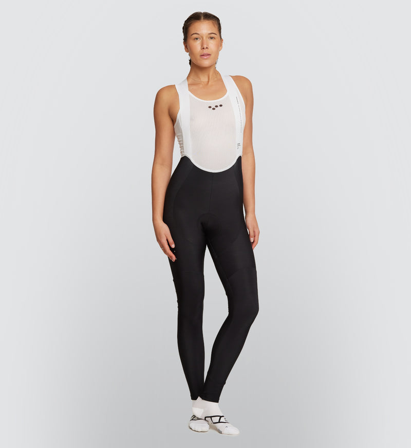 Front view of the Black Women's SuperFLEECE 2.0 Cycling Bib Tights, featuring an advanced brace system and tailored fit for superior support and mobility.