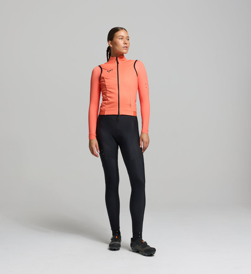 Front view of female cyclist in apricot thermal gilet – sleek, standard-fit winter layer with SAB waterproof two-way zipper and soft, flexible membrane fabric.