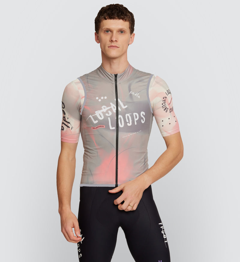 Front view of model wearing LOCAL LOOPS Men's Classic Cycling Gilet in Club Stone, featuring a windproof vest design with a water-resistant two-way YKK zipper and flexible fit for year-round weather protection on bike rides.