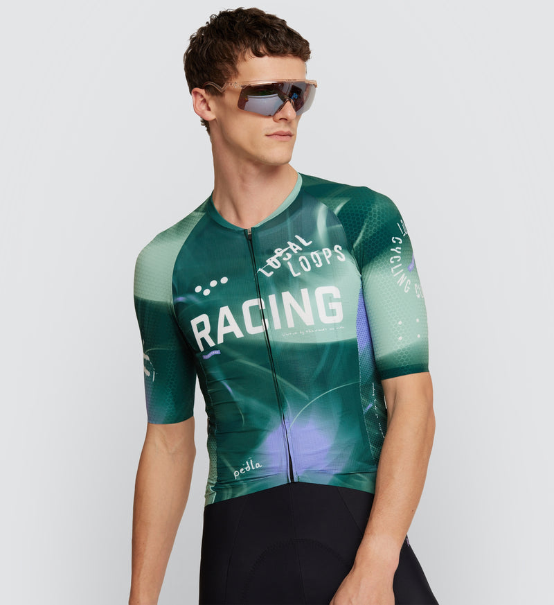 Front view of model wearing LOCAL LOOPS Men's Pro Pursuit 2.0 Cycling Jersey in Race Pine, showcasing a sleek race-fit design with AeroPRISMA short sleeves, lightweight fabric, and reflective accents for high visibility during bike rides.
