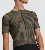 lose-up of the Khaki Dye Off Grid Men's Gravel Jersey fabric, highlighting UPF 40+ protection and durable external sleeve panels for rugged cycling adventures.
