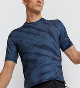Close-up of the Indigo Tie Dye Off Grid Gravel Tech Tee fabric, focusing on the breathable design and unique tie-dye pattern for cycling performance.