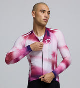 Close-up detail of AeroPRISMA sleeve fabric and welded hem on the Men's Pursuit LS 2.0 Jersey in AirFoils Hot Pink, emphasizing aerodynamic texture and premium Italian material quality.