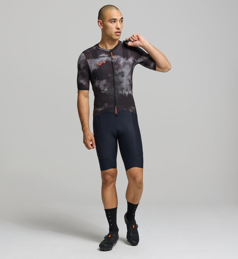 Front view of male cyclist wearing dark purple SuperSYSTEM jersey – bonded hem and breathable stretch fabric for performance comfort