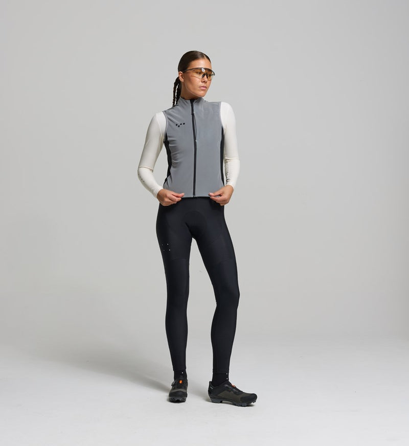 Female cyclist wearing reflective gilet; sleek front fit with full-coverage visibility for low-light rides.