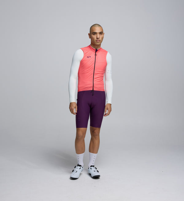 Front view of cyclist wearing Coral Plum Classic LITE Gilet – windproof, water-resistant front and reflective detailing for all rides