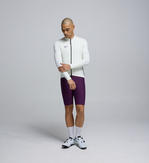 Front view of cyclist wearing Porcelain Midweight Long Sleeve Jersey – articulated sleeves and clean seam detailing for modern comfort