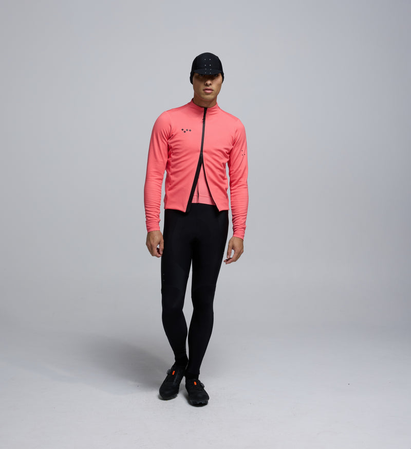 Front view of cyclist wearing Coral Thermal Jacket – thermal performance knit with waterproof two-way zipper for cold-weather rides