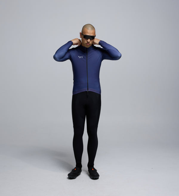 Front view of male cyclist wearing Pedla Dusk Thermal LS Jersey – showcasing refined fit, reflective logos, and winter-ready features