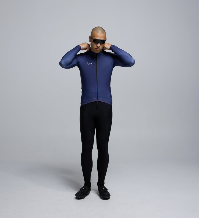 Front view of male cyclist wearing Pedla Dusk Thermal LS Jersey – showcasing refined fit, reflective logos, and winter-ready features