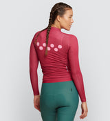 Back view of Women's Air Long Sleeve Cycling Jersey in Raspberry - Minimalist back pocket and reflective elements.