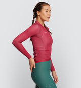 Side view of Women's Air Long Sleeve Cycling Jersey in Raspberry - Extended sleeves and breathable underarm mesh.