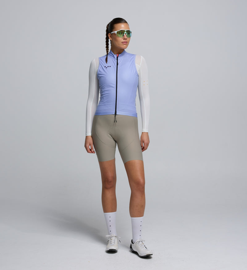 Front view of female cyclist wearing Galactic Lilac Classic LITE Gilet – streamlined fit with reflective details for safety