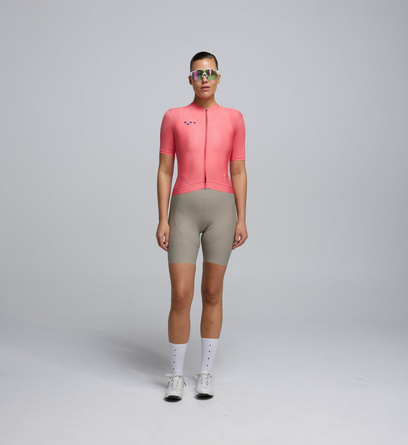 Front view of female cyclist wearing Coral Classic Jersey – extended sleeves and contoured fit for comfort and performance