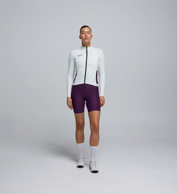 Front view of cyclist in Porcelain Midweight Long Sleeve Jersey – articulated sleeves and clean seam detailing for modern cycling comfort