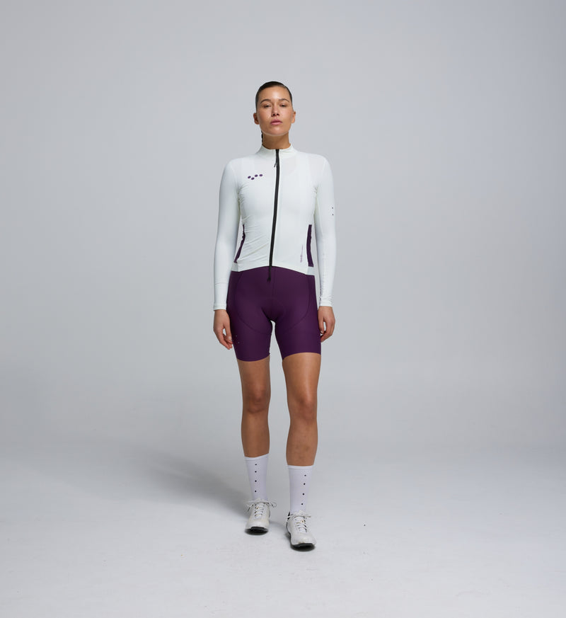 Front view of cyclist in Porcelain Midweight Long Sleeve Jersey – articulated sleeves and clean seam detailing for modern cycling comfort