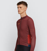 Side view of Men's Rust Long Sleeve Cycling Jersey highlighting easy-access side body pockets and ergonomic lines