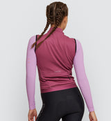 Back view of the Thermal Cycling Gilet in Rose, featuring a large back pocket with concealed zip for secure storage