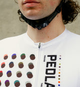 Close-up of the white cycling jersey fabric, showcasing moisture-wicking properties, four-way stretch, and form-fitting design for the best road cycling experience.