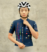 Model wearing the COLOUR THEORY Women's Classic Cycling Jersey in navy, showcasing moisture-wicking fabric, a low-cut collar, and a comfortable fit for cycling.