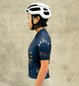 Side profile of the Women's Classic Cycling Jersey in navy, highlighting the ergonomic design, underarm ventilation panels, and four-way stretch fabric.
