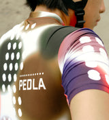 Close-up of the Spectrum White cycling jersey fabric, highlighting moisture-wicking properties, breathable SPF 50 material, and durable craftsmanship.