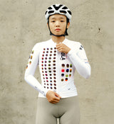 Model wearing the COLOUR THEORY Women's Classic Long Sleeve Cycling Jersey in white, showcasing a streamlined fit, long sleeves, and breathable fabric for cycling.