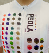 Close-up of the LunaAIR white cycling jersey fabric, highlighting breathable mesh, moisture-wicking properties, and durable craftsmanship for summer rides.