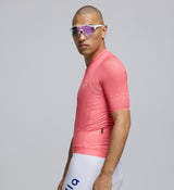 Side view of Men’s Air Jersey in Coral with extended sleeves, breathable panels, and low-profile storage