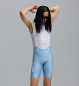 Pedla SuperFIT 2.0 men's powder blue cycling bib shorts close-up, Italian breathable fabric, mesh white bib, Elastic Interface chamois, seamless non-stitched cuff, reflective logos, aerodynamic muscle-support fit for performance cycling