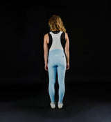 Back view of women's Pedla SuperFIT 2.0 powder blue cycling bib tights with white breathable mesh bib, Elastic Interface chamois, aerodynamic fit, seamless non-stitched cuffs, reflective logos, high-support Italian fabric