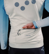 Women's thermal cycling gilet in porcelain, close-up of windproof waterproof performance knit, soft matte finish, SAB two-way zip, hem gripper, concealed rear zip pocket and reflective chest/back/shoulder details for winter cycling
