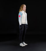 Womens porcelain thermal cycling gilet side view, windproof waterproof thermal knit vest with soft matte finish, SAB two-way waterproof zip, reflective details, hem gripper and concealed rear pocket, lightweight winter layer