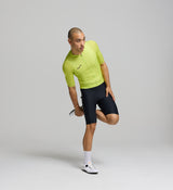 Side profile of electric lime men’s cycling jersey – contoured performance silhouette with ventilation across high-heat zones, designed for long climbs and warm-weather riding.