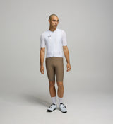 Front view of male cyclist in Core White Classic Jersey – form-fitting silhouette with extended sleeves and low collar designed for aerodynamic road performance.