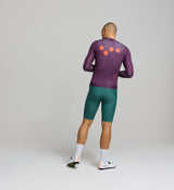 Rear view of aubergine cycling jersey – minimal and reinforced back pocket design, mesh back panel for ventilation, and streamlined silhouette for endurance efforts in heat.