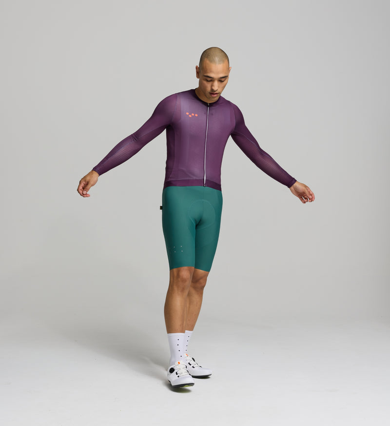 Front view of male cyclist in aubergine Air Long Sleeve Jersey – slim performance fit with mesh panels on the chest and sleeves for airflow and cooling on hot rides.