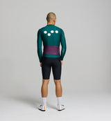 Rear view of pine green long sleeve cycling jersey – rear pockets for ride essentials, soft silicone hem gripper, and sculpted rear panel for a secure fit on the bike.
