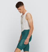 Side view of Men's SuperFIT 2.0 Bib Shorts in Evergreen, showing the seamless cuff and reflective logos for safety