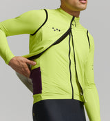 Close-up of electric lime thermal fabric and hem gripper – waterproof membrane, soft brushed inner surface, and 2.5CM silicone band for a secure fit in tough riding conditions.
